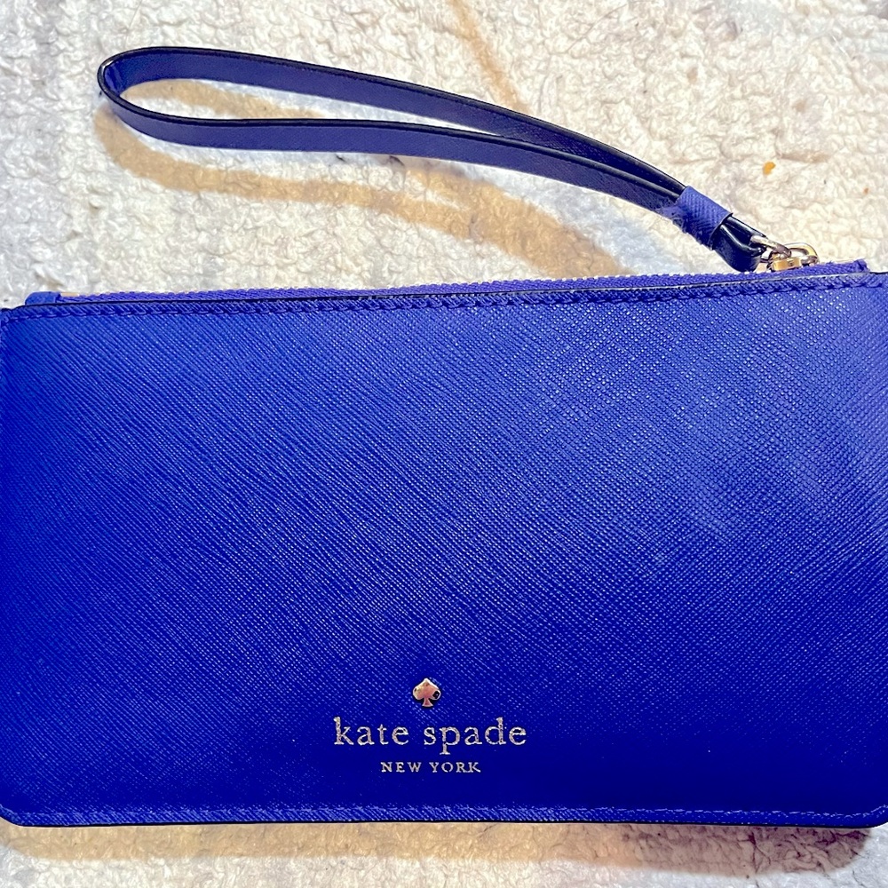 Like new Kate Spade wristlet wallet!Normal wear and tear,but nothing noticeable!